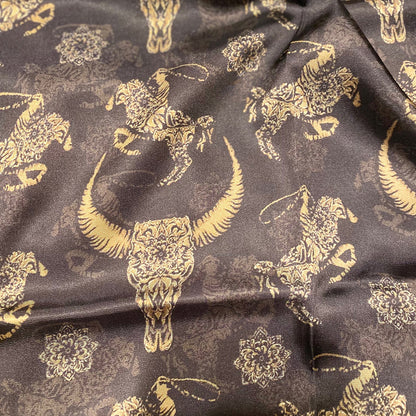 Wild Thang Wild Rags gold cowboy roper and steer skull designs on a brown background